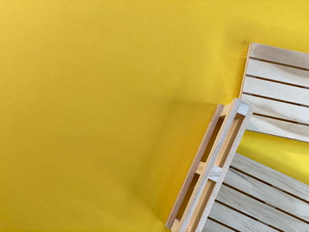 Wooden pallets are lying on a yellow backgroundの写真素材