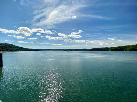 slightly cloudy sky sunny day over Lake Solinie you can see the tops of the Bieszczady Mountains covered with coniferous forestsの写真素材