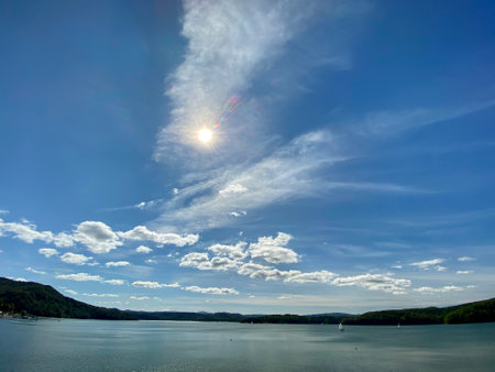 slightly cloudy sky sunny day over Lake Solinie you can see the tops of the Bieszczady Mountains covered with coniferous forestsの写真素材
