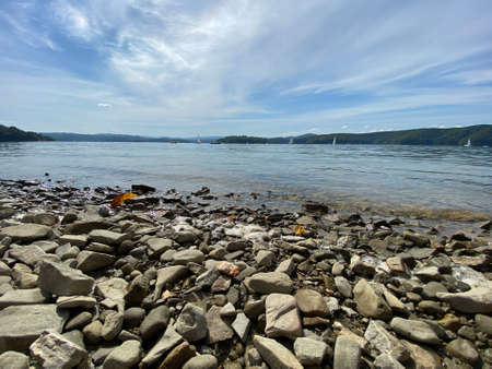 Lake Solinskie with a stony beach visible mountains of the Bieszczady Mountains in the Podkarpackie...
