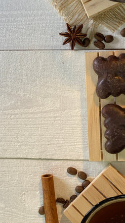 there are cups with coffee on wooden jute napkins the bottoms are gingerbreads everything is lying...