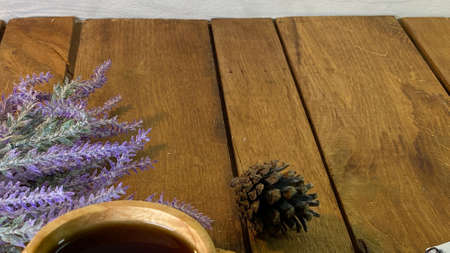 table made of oak planks you can see jars on them there is a bouquet of lavender wooden cup with...