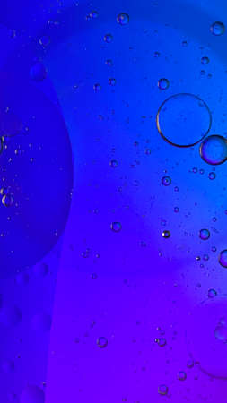 abstract macro photography colorful background oil drops and air bubbles floating on waterの写真素材