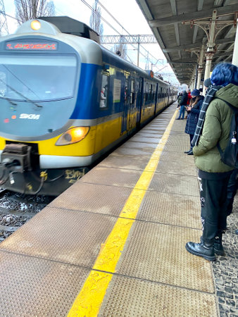 Sopot, Pomorskie Voivodeship, January 8, 2022. Peony railway station covered with a roof, an approaching passenger trainのeditorial素材