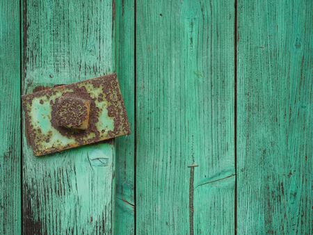 Closeup of an old green wooden door with rusty handleの写真素材