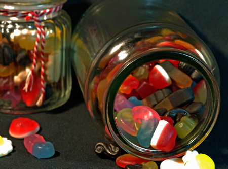 Colorful gummy candies in glass jars Delicious. Combination of vegetarian and non vegetarian sweets.の写真素材
