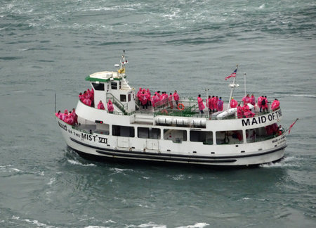 Niagara Falls, Ontario, Canada - October 18, 2016: The Maid of the Mist VII carries tourists to the base of the Horseshoe Falls. The passengers wear all the same red raincoats against the water mistのeditorial素材
