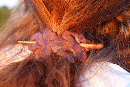 Red hair of a woman with a gecko shaped wooden hair clipの写真素材