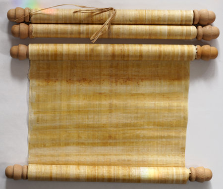 Two papyrus scrolls, one rolled open with space for your own text, one closedの写真素材