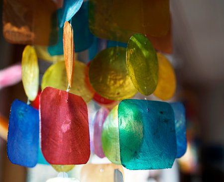 Part of a mobile with lovely mother-of-pearl parts. It catches sunlight and moves in the windの写真素材