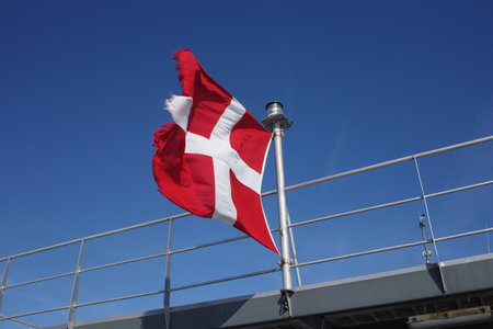 A fluttering flag in a strong wind. The flag is starting to frayの写真素材