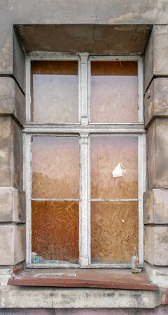 Broken glass in old wooden window of old tenement house in Wroclaw city