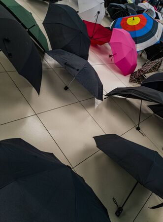 Umbrellas lying on floor in waiting room の写真素材