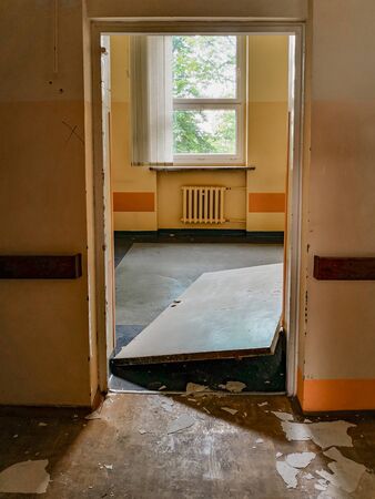 Forced doors of old abandoned hospital roomの写真素材
