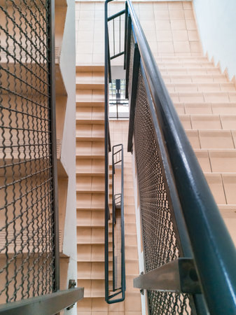 Top down view to modern staircase with light stairs and metal railingsの写真素材