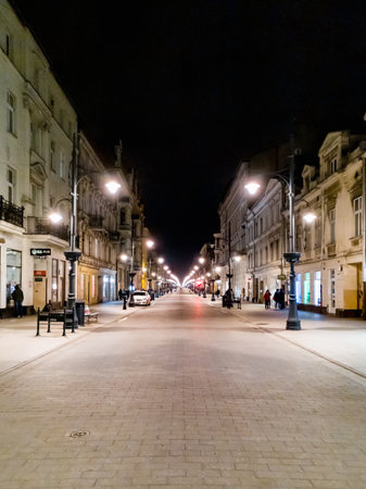 Lodz, Poland - February 21 2020 Center view to long Piotrkowska street with symmetrical lanterns at nightのeditorial素材