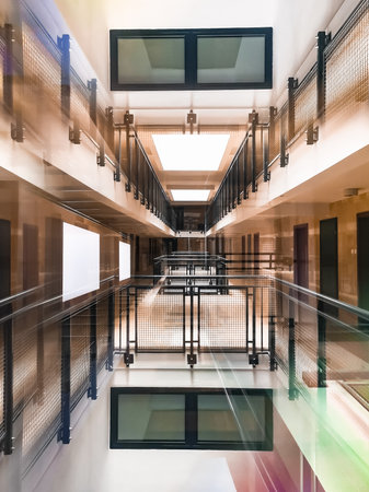 Lodz, Poland - February 22 2020 Prismatic look to long corridor with small apartments on sides