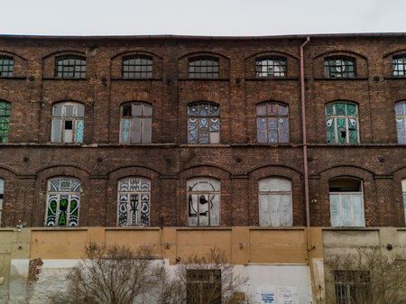 Lodz, Poland - February 23 2020 Facade of old red brick building with colorful decorations in windowsのeditorial素材