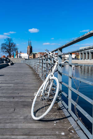 Wroclaw, Poland - March 8 2020 White bicycle at boulevard near railingのeditorial素材