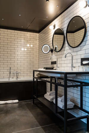Wroclaw, Poland - March 7 2020 Interior of a beautiful toilet with white tiles on the wall and black partsのeditorial素材