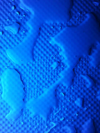 Splashes of water on shower tray highlighted in colorの写真素材