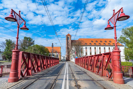 Wroclaw, Poland - May 3 2020: Red steel construction on sand bridge to island at city centerのeditorial素材