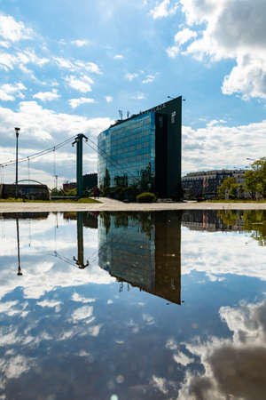 Wroclaw, Poland - May 3 2020: Hotel Park Plaza reflected in puddleのeditorial素材