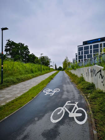 Wroclaw, Poland - June 20 2020: Sidewalk and bicycle path next to business garden corporate squareのeditorial素材