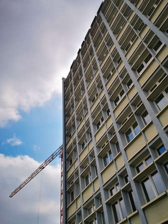 Wroclaw, Poland - June 25 2020: High corporate office building with high crane behind