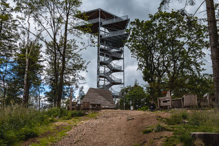 Walbrzych Mountains, Poland - July 7 2020: Tower on top of Trojgarb mountain at cloudy day
