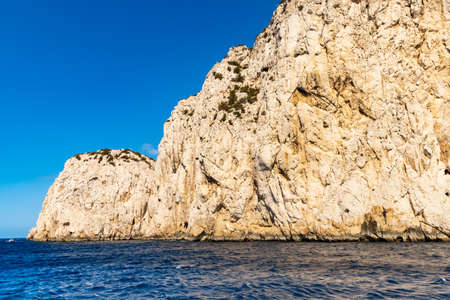 Edge of high cliff next to the sea at sunny day on Capri islandの写真素材