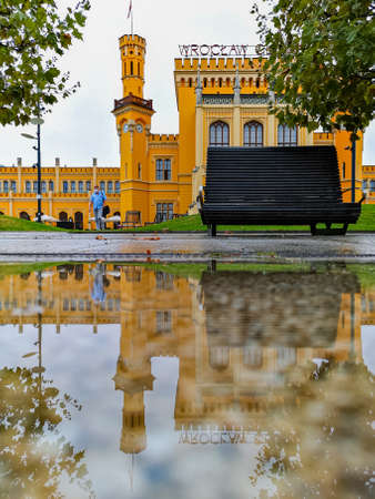 Wroclaw, Poland - September 25 2020: Old building of main railway station reflected in small puddleのeditorial素材