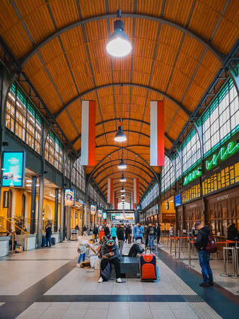 Wroclaw, Poland - October 17 2020: Interior of main railway station building full of white and red flags and peopleのeditorial素材