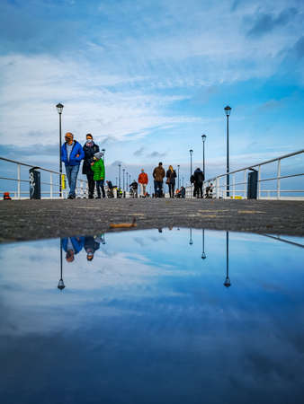 Gdansk, Poland - October 24 2020: Pier in Brzezno at cloudy morning reflected in glassy tile