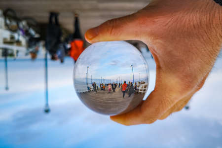 Gdansk, Poland - October 24 2020: Pier in Brzezno at cloudy morning reflected in crystal glassy lensballのeditorial素材