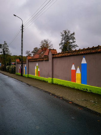 Oborniki Slaskie, Poland - October 31 2020: Brick fence of kindergarten with painted on colorful crayonsのeditorial素材