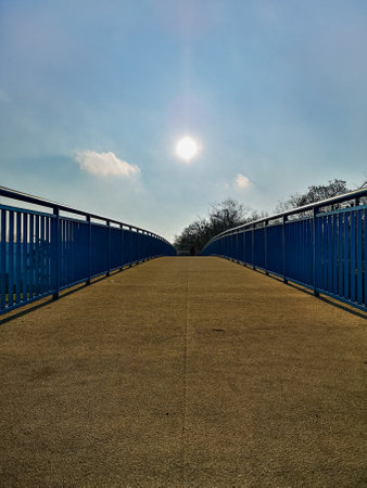 Small bridge over roads with blue metal railings on both sidesの写真素材