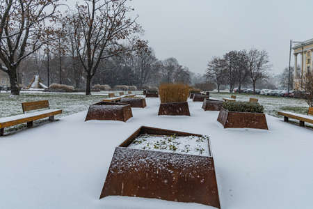 Wroclaw, Poland - December 3 2020: Small square in park next to promenade full of trees and bushes in flower potsのeditorial素材