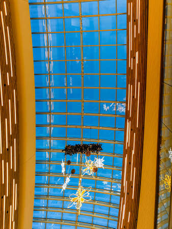Wroclaw, Poland - December 20 2020: Glass ceiling of corridor in Wroclavia shopping mall with hanging christmas decorations under itのeditorial素材