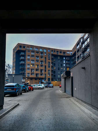 Wroclaw, Poland - December 17 2020: Facade of modern estate buildings with colorful cars at parking...