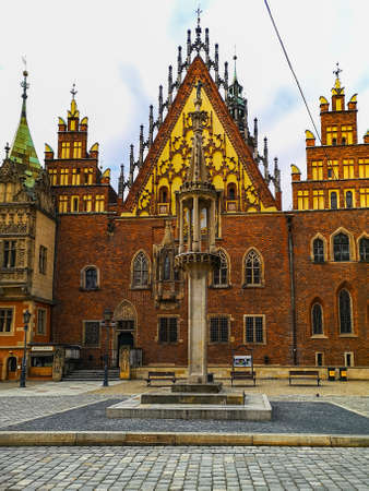 Wroclaw, Poland - January 2021: Town hall with pillory statue in front of at cloudy day