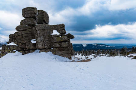 Snowy landscape of mountain trails and hills at cloudy morningの写真素材