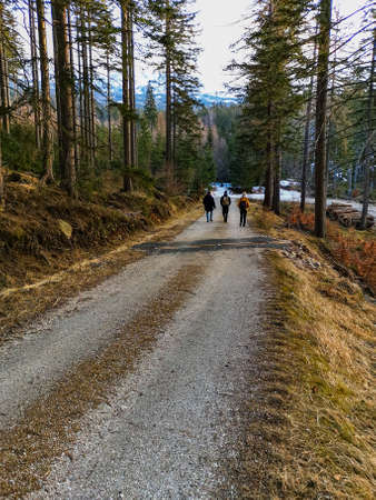People walk through long mountain trail at cloudy afternoonの写真素材