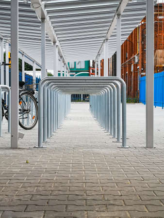 A lot of bike parking places with metal pipes looks like tunnelの写真素材