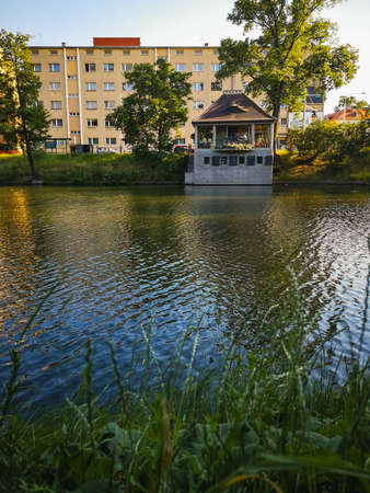 Wroclaw, Poland - June 2021: Big block of flat and small cafe over small city moat at sunny dayのeditorial素材