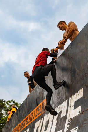 Poznan, Poland - June 2021: An hard extreme obstacle course Survival Race at rainy day