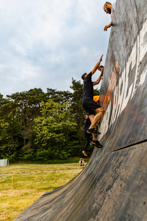Poznan, Poland - June 2021: An hard extreme obstacle course Survival Race at rainy day