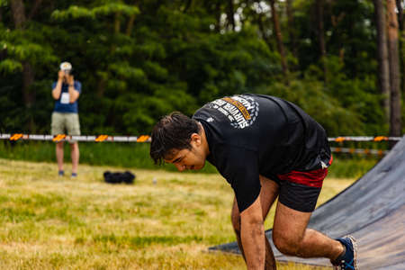Poznan, Poland - June 2021: An hard extreme obstacle course Survival Race at rainy day