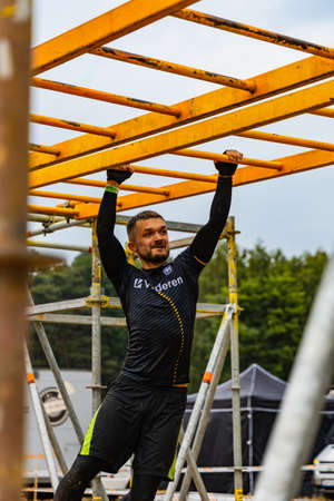 Poznan, Poland - June 2021: An hard extreme obstacle course Survival Race at rainy day