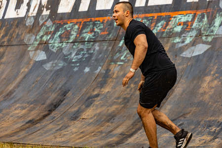Poznan, Poland - June 2021: An hard extreme obstacle course Survival Race at rainy day